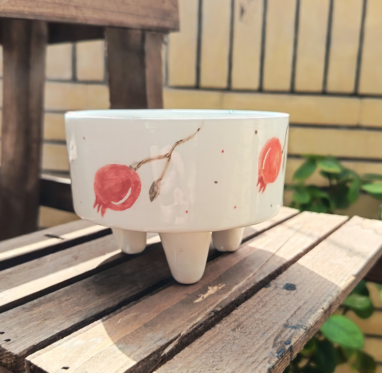 Handmade ceramic pedestal dish with pomegranate design